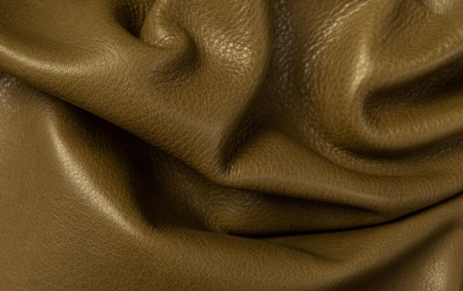 Artisan materials — pebbled grain leather, hand-dyed suede, linen weaves